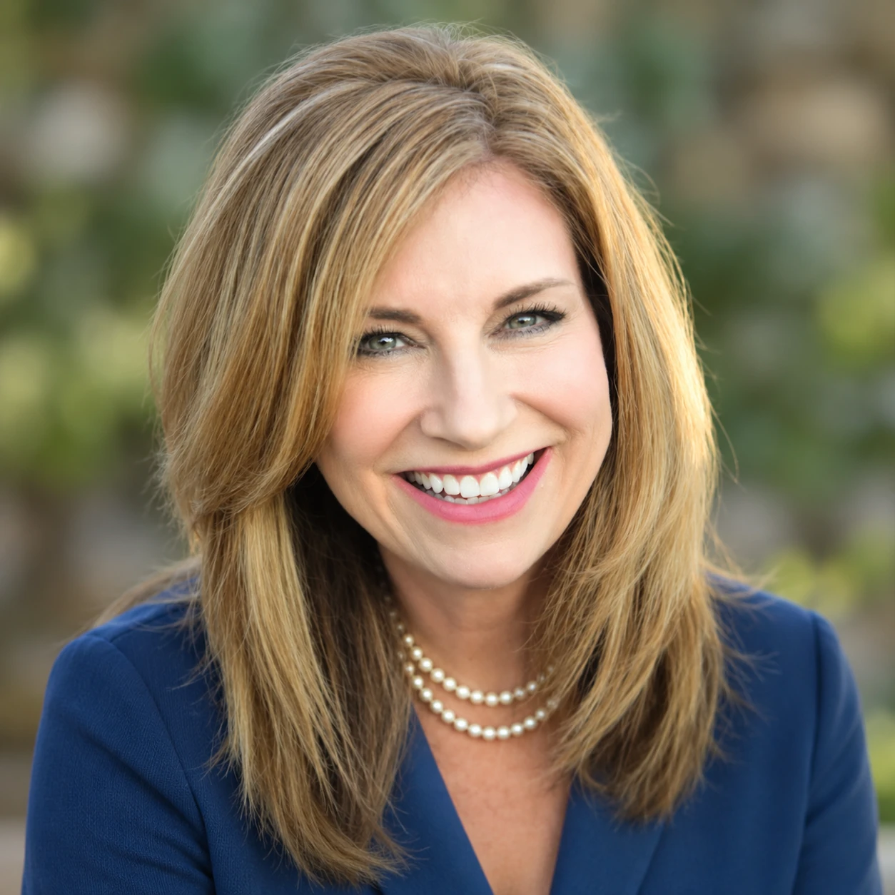 Pamela Gorman, founder of 21Five Consulting, outdoors in a garden.